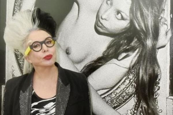 French artist Orlan poses in front of a self-portrait at the Ceysson and Bénétière gallery in 2021 in Paris.