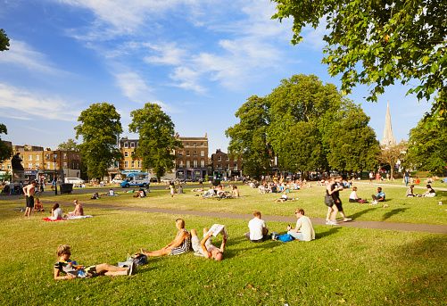 People sitting in a park in Wandsworth